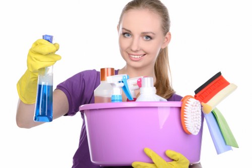 Cleaner wearing PPE during a professional cleaning task in Finsburypark