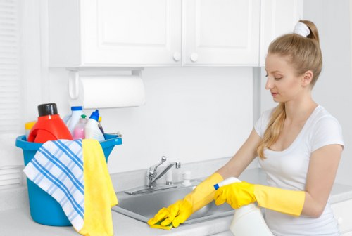 Cleaning team wiping surfaces and removing plaster dust after renovation